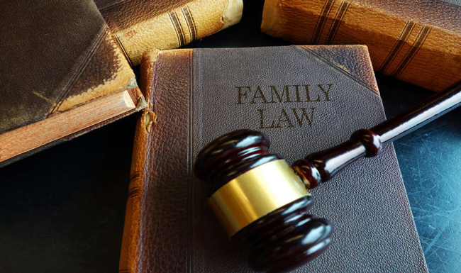 A family law book with a gavel placed on top.